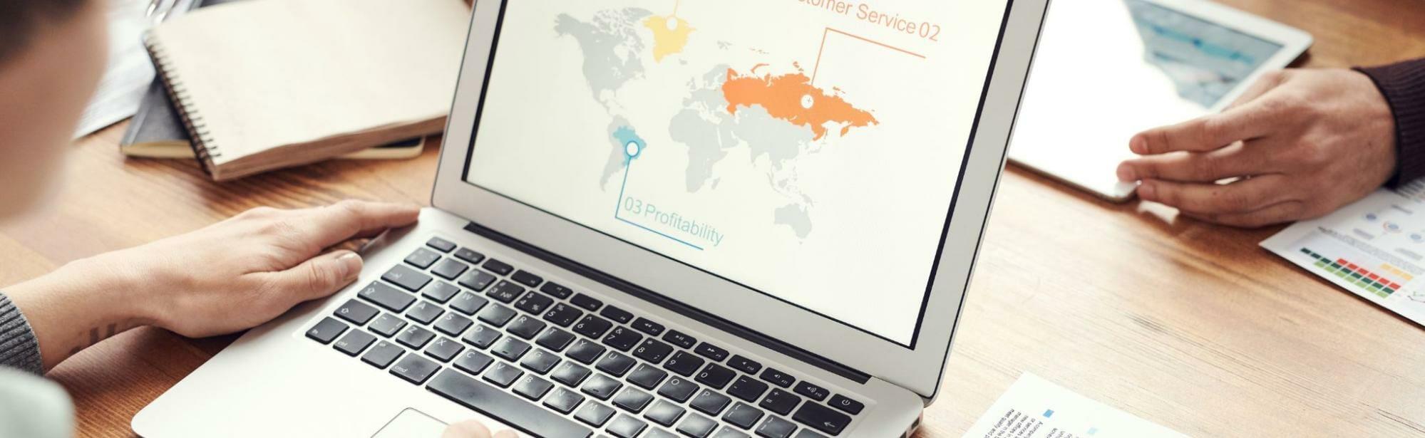 a person using a laptop and selling globally on Shopify